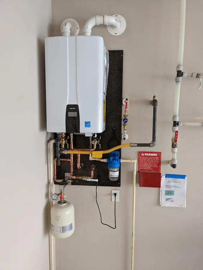 Professional plumber installing copper piping in a South Point home